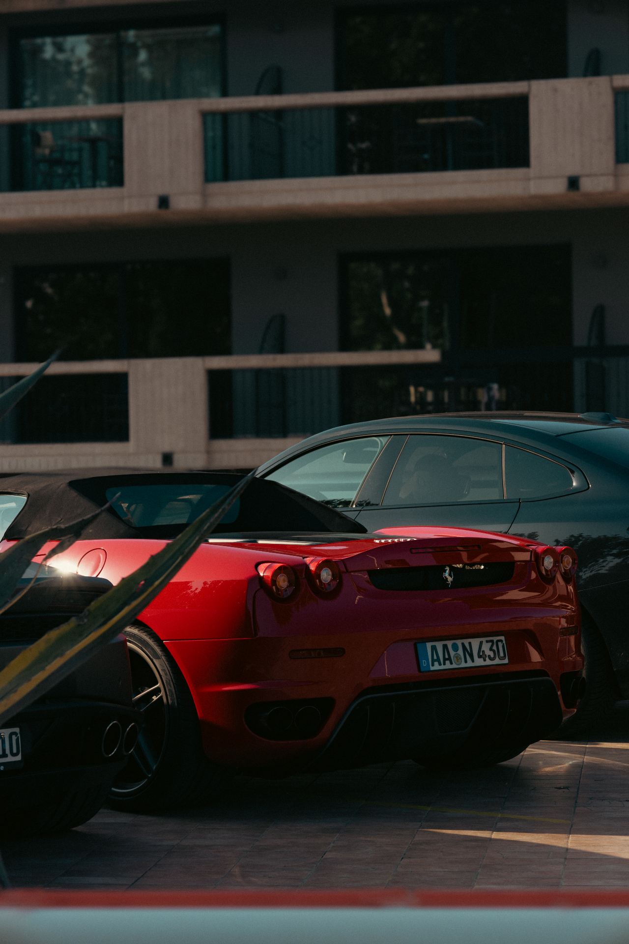 Red Ferrari F430 parked at golden hour