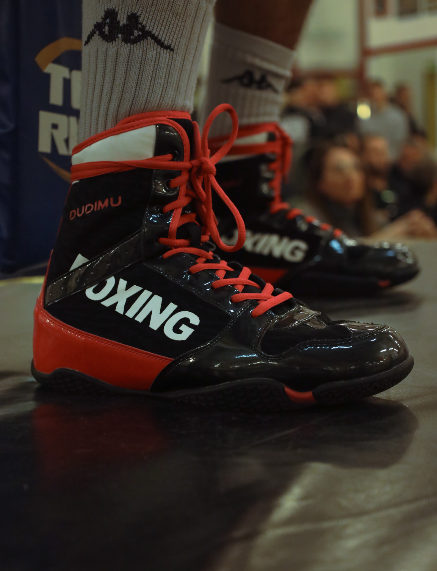 Close-up of red and black boxing boots ringside