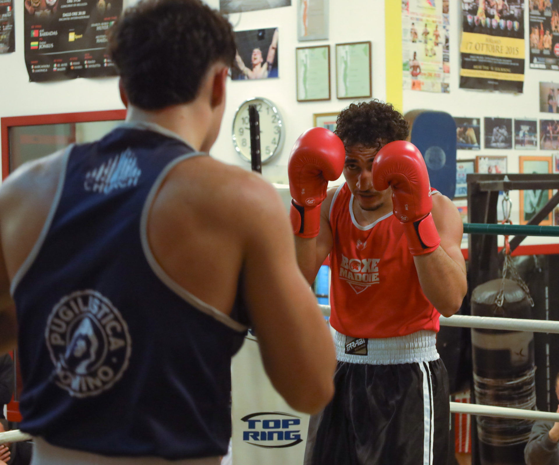 Boxer in red guard up during sparring at Boxe Madone