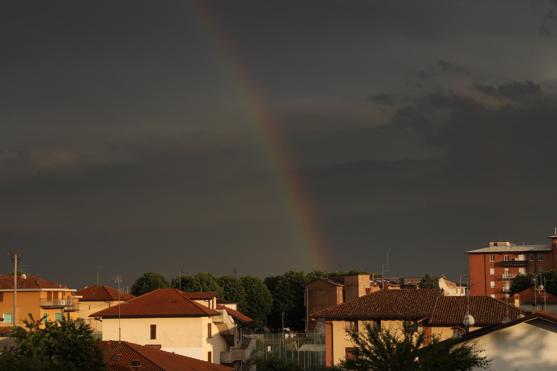 Rainbow over Italian rooftops after a storm