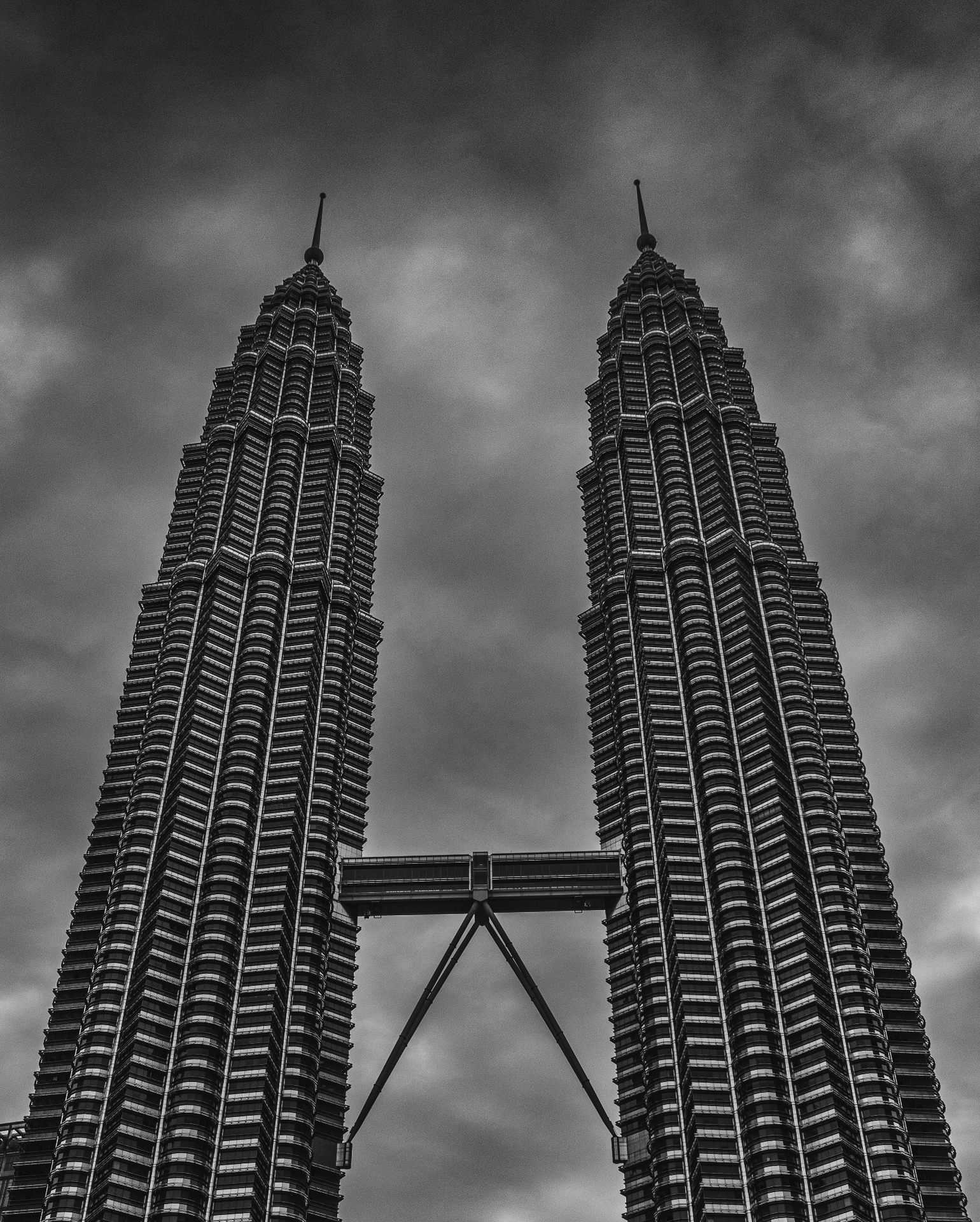 Petronas Twin Towers in black and white under stormy sky