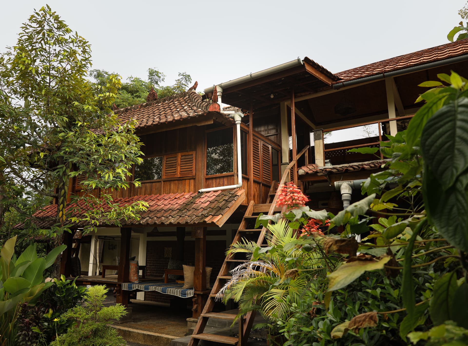 Traditional Balinese teak villa surrounded by tropical garden